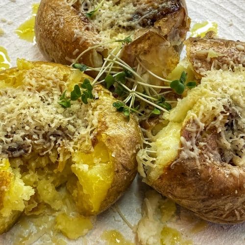 Baked smashed potatoes with garlic sauce and parmesan