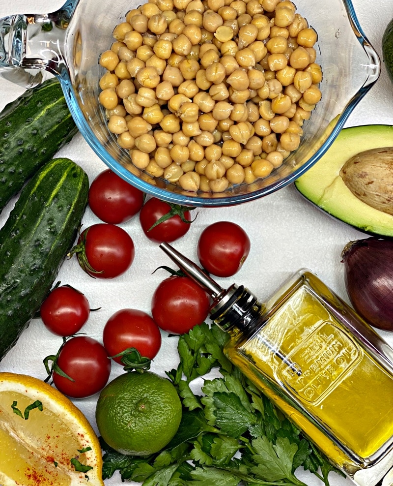 Chickpeas and avocado salad with olive oil dressing and the ingredients