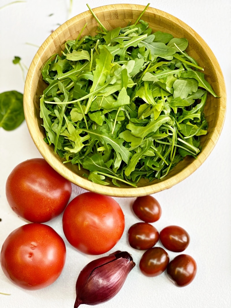cherry tomatoes arugula red onion wooden salad bowl